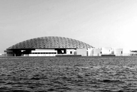 A building capped with a dome on the ocean.