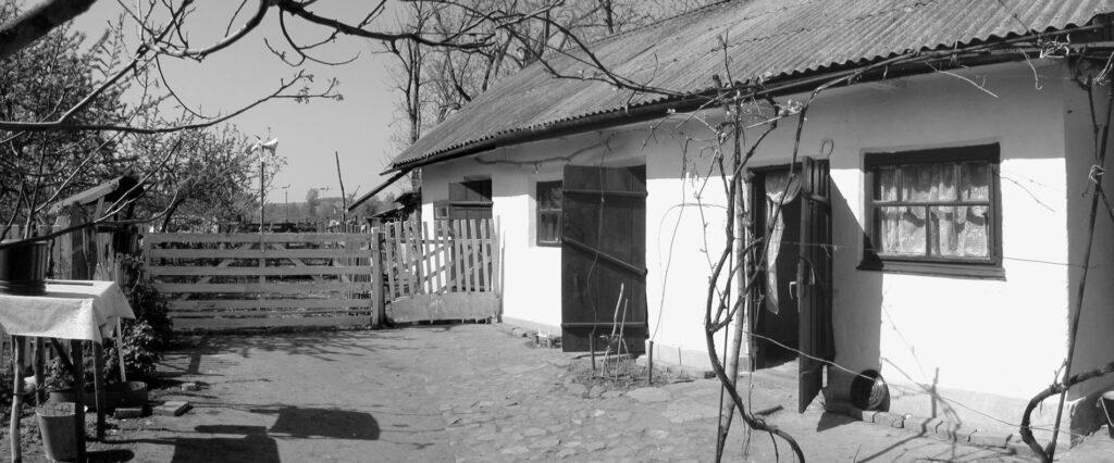 A cabin and dirt courtyard in daylight