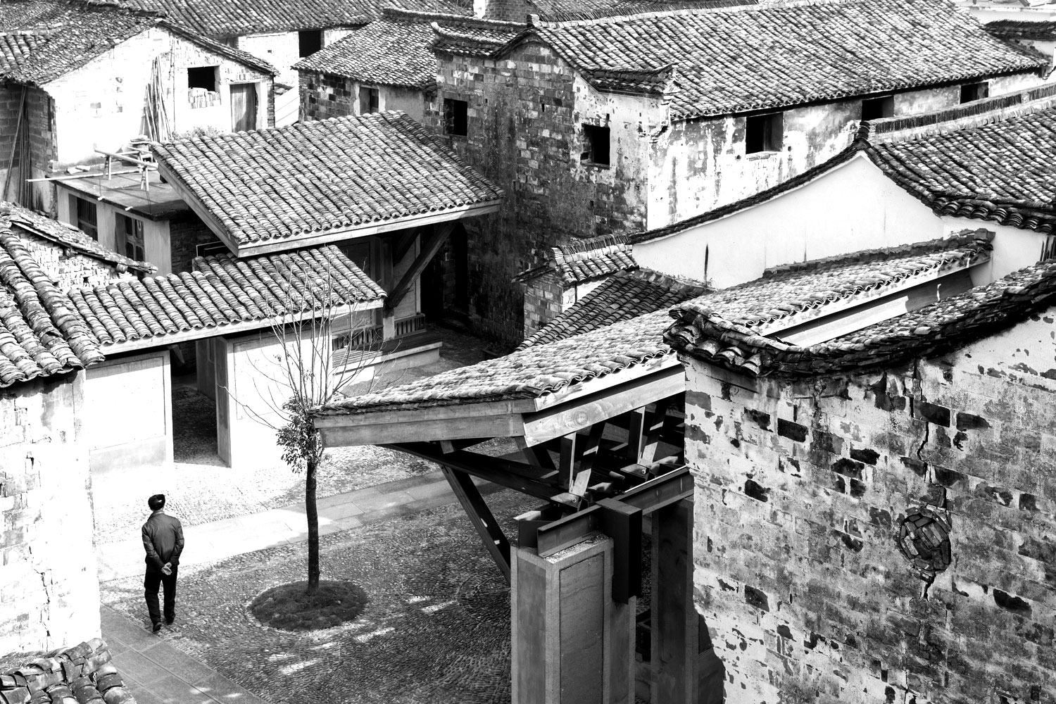 Black and white photograph of buildings and a courtyard from above