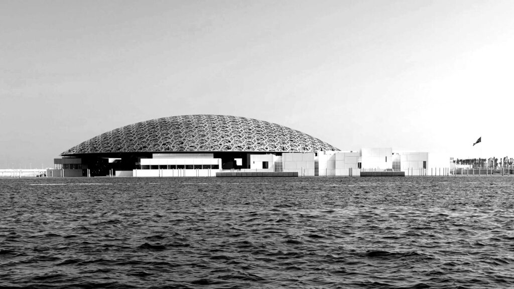 Dome-shaped building in daylight surrounded by water.