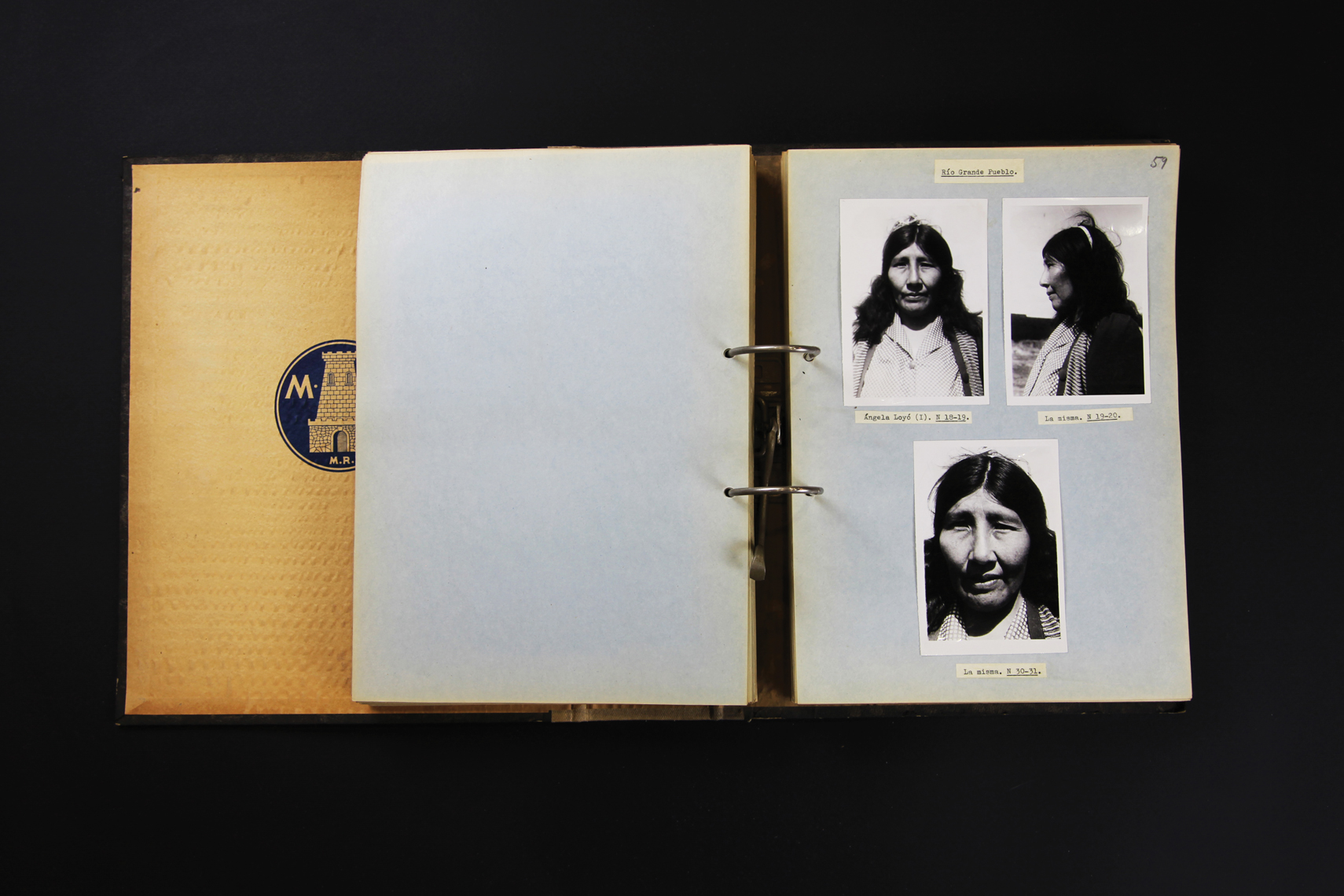 Open binder with right page showing three black and white photographs of a person.