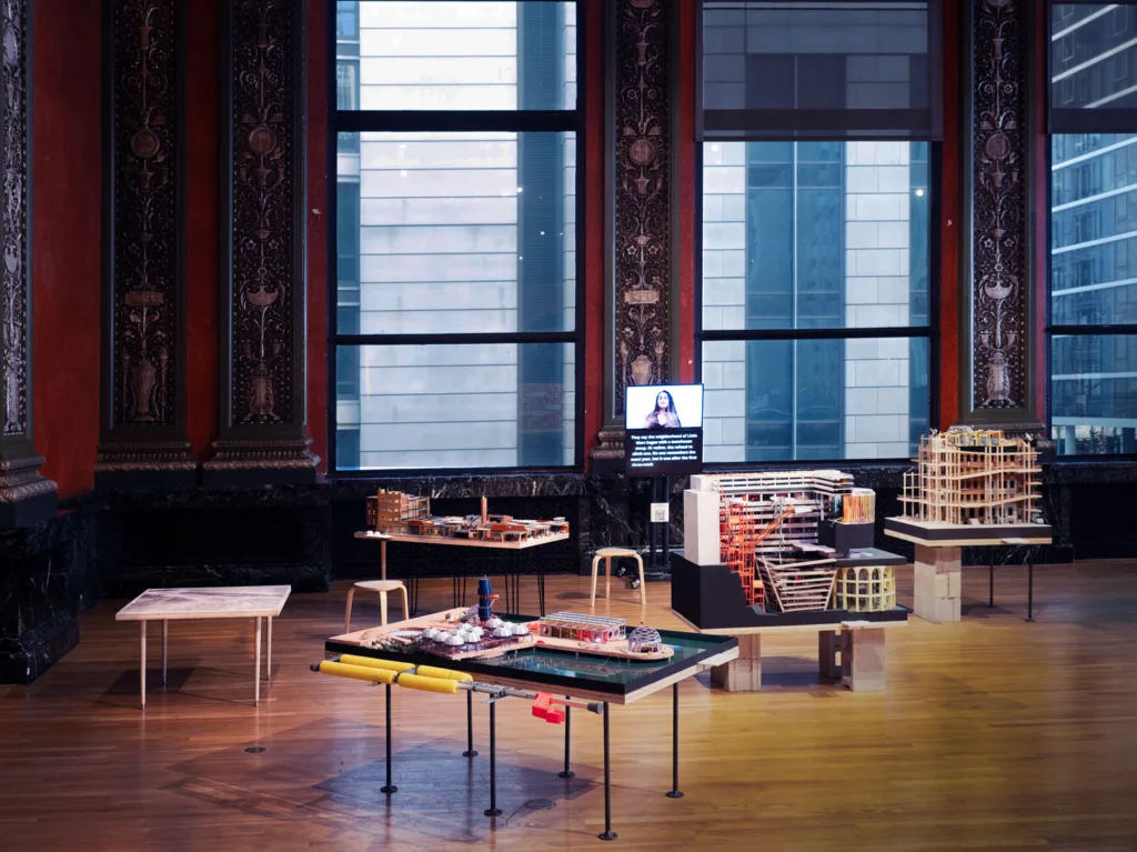 A group of models of structures arranged in a gallery. 