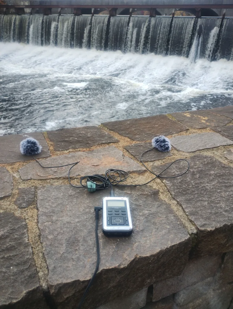 Recording equipment pointed at a dam. 