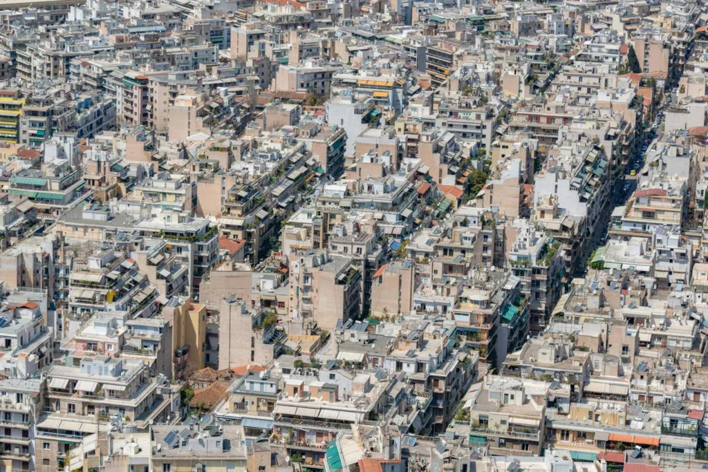 Aerial view of tightly developed city with litter greenery.