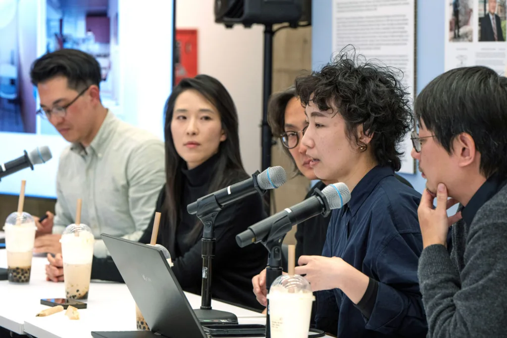 A group of people speaking at an event at the GSD. 