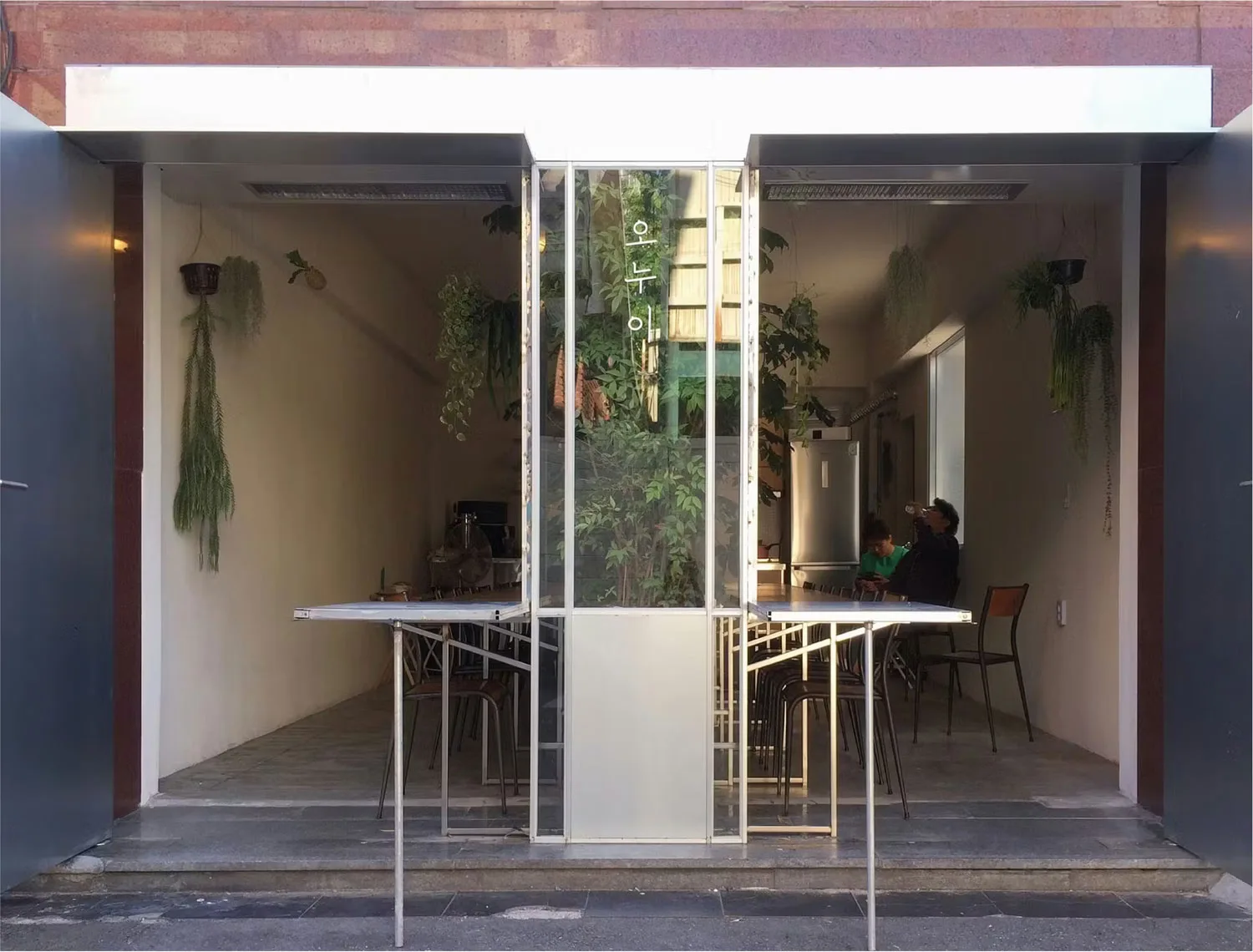 A cafe in Korea with a foldable outdoor table in the front. 