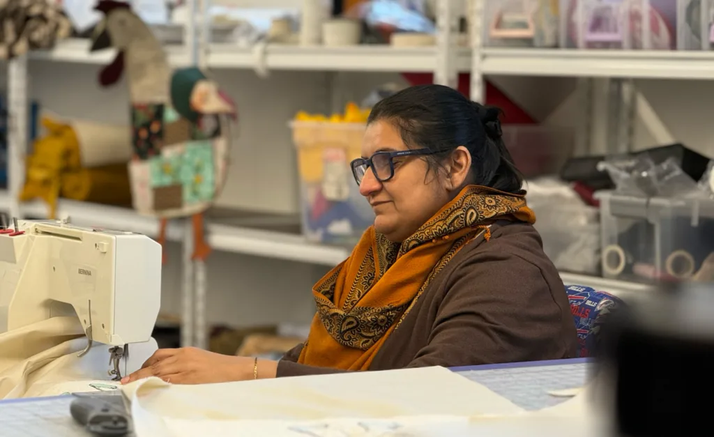 Woman at a sewing machine.