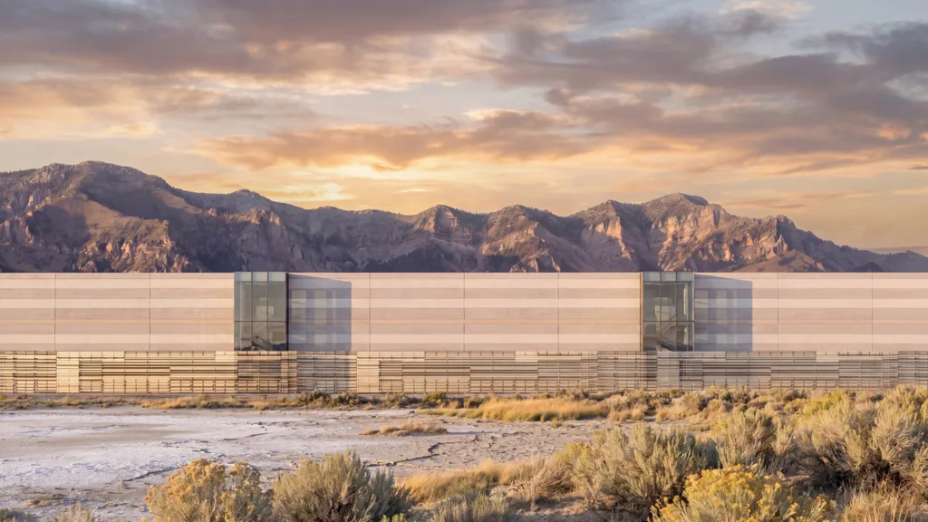 A large beige building sits in a desert landscape.