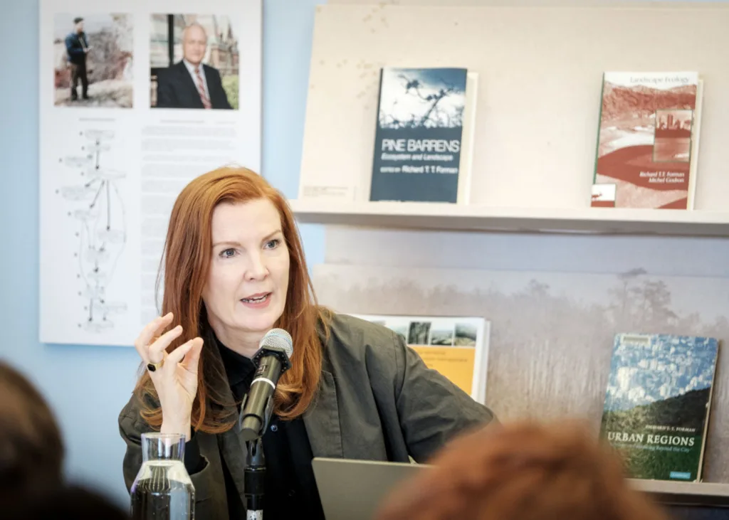 Kate Crawford speaking at a microphone.