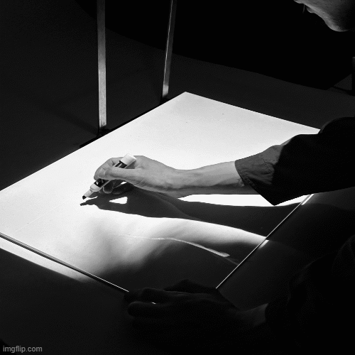 Person sketching on a board.