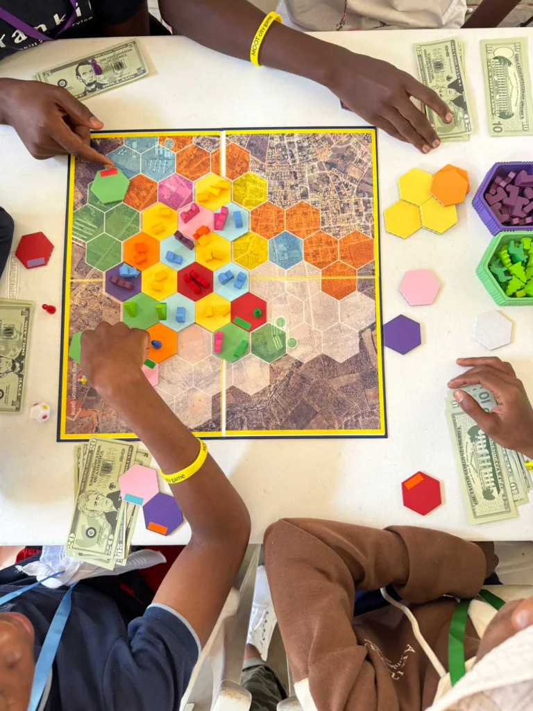 Colorful game board with people playing.