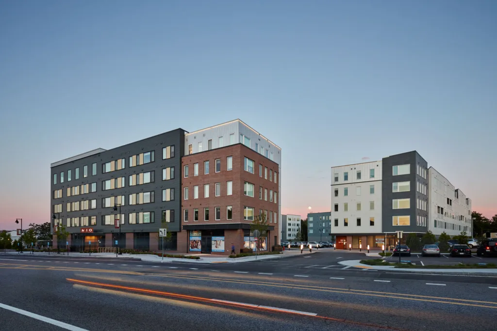 Multi-story buildings on a street at dusk.